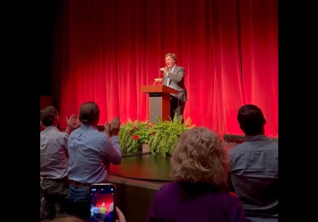 Tucker Gets Standing Ovation At First Public Appearance Since Removal